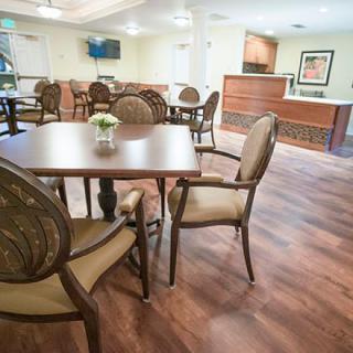 A well-furnished dining area with elegant chairs and a wooden floor.