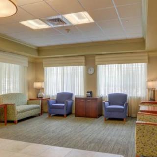 A modern waiting room with comfortable seating and ample natural light.