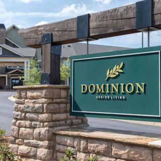 Entrance sign for Dominion surrounded by stone pillars and landscaping