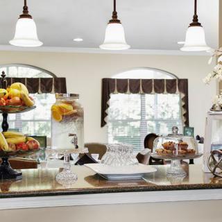 A cozy kitchen counter with fruit displays and charming decor.