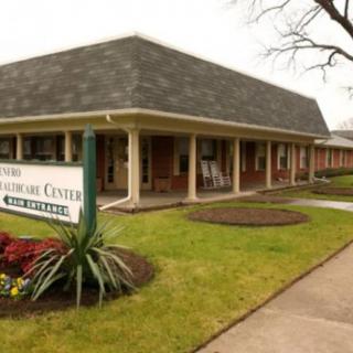 A healthcare center building with landscaped surroundings.