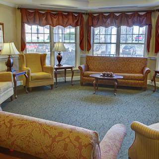 A cozy living room with sofas, armchairs, and a coffee table.