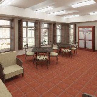 A well-lit room with tables and chairs, featuring large windows and a minimalist design.