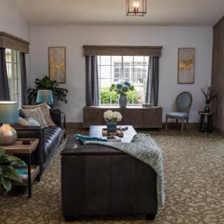 A cozy and stylish living room featuring comfortable seating, decorative plants, and ample natural light.