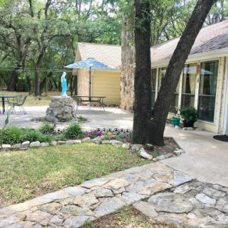 A peaceful outdoor space showcasing natural beauty with stone pathways and a tranquil garden.