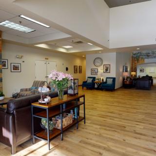 A spacious and well-decorated lobby area with comfortable seating and wooden flooring.