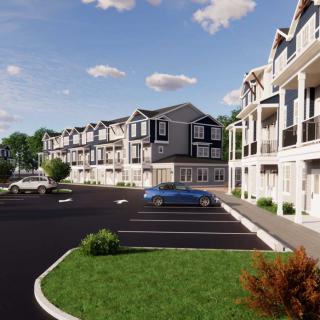 A modern apartment complex with a large parking lot, surrounded by landscaped greenery under a partly cloudy sky.