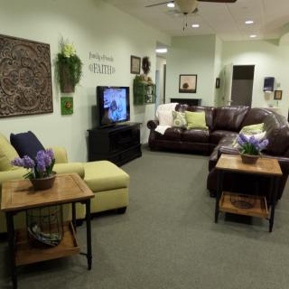 A cozy living room with comfortable seating, a TV, and tasteful decor.