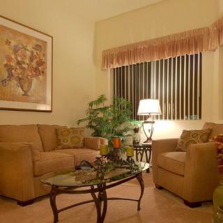 A cozy living room with comfortable seating, warm lighting, and elegant decor.