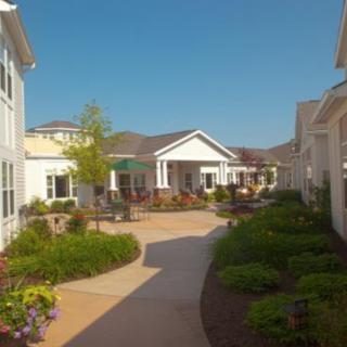A sunny day in a well-maintained residential community with lush gardens and clean pathways.
