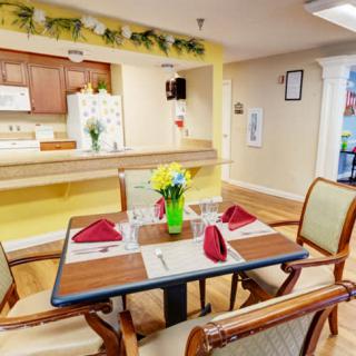 A cozy dining area with a neatly set table and vibrant decor.