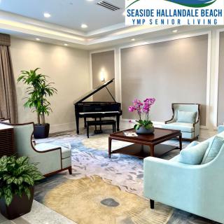 Elegant living room with a grand piano, comfortable seating, and lush plants.