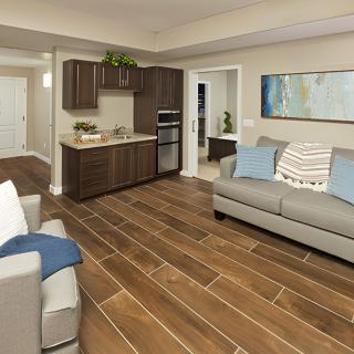 A modern open-concept living room and kitchen area with wooden floors and stylish decor.