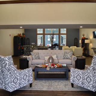 A beautifully designed living room with patterned armchairs, a comfortable sofa, and a stylish coffee table.