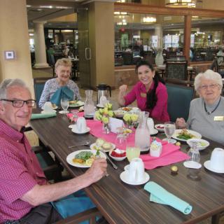 A group of people enjoying a meal together at a community dining area.