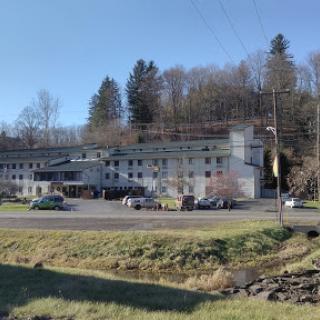 A charming motel nestled among trees, showcasing a serene outdoor landscape.