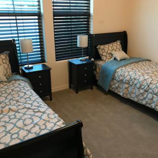 A cozy bedroom with twin beds and matching decor.