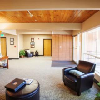 A modern lobby or waiting area with comfortable seating and large windows.