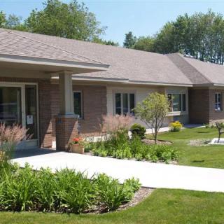 A suburban house with a neatly maintained lawn and garden.