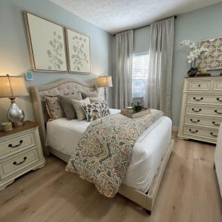 A cozy bedroom decorated with soft colors and elegant furniture.