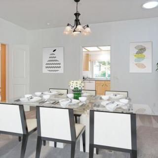 A modern dining room with a set table and contemporary decor.