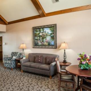 A cozy living room with a sofa, armchair, and decorative elements.