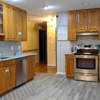 A modern kitchen with wooden cabinets and stainless steel appliances.