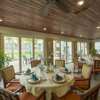 A beautifully set dining room with elegant decor and large windows letting in natural light.