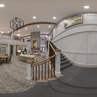 A stylish interior lobby featuring a staircase and contemporary design elements.