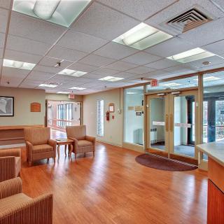 A spacious and well-lit waiting room with comfortable seating.