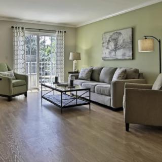 A cozy living room with modern furniture and a large window providing natural light.