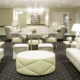 A luxurious modern living room with elegant white furniture and decor.