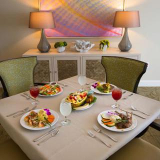A beautifully set dining table featuring a gourmet meal and elegant decor.