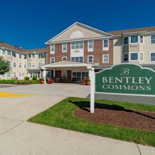 A view of the Bentley Commons assisted living facility with a clear blue sky background.