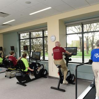 Individuals engaged in a cardio workout session at a fitness center.