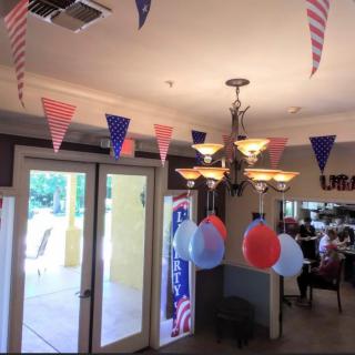 Indoor party with festive decorations and balloons.