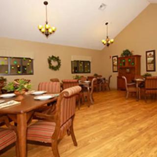 A cozy dining room with elegant wooden furniture and warm lighting.