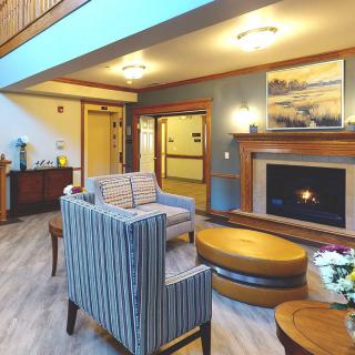 A modern living room featuring a cozy fireplace and stylish furniture.