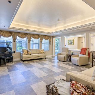 Spacious and elegantly decorated living room with comfortable seating and a grand piano.