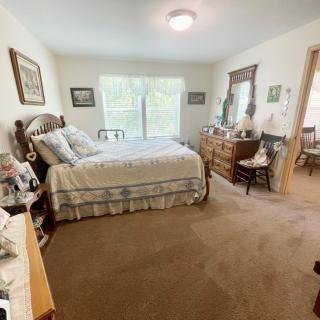 A cozy bedroom with a large bed and classic wooden furniture.