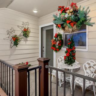 A beautifully decorated front porch ready for the holiday season.