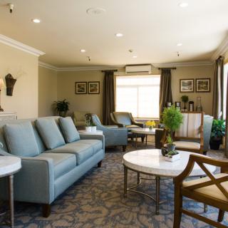 A cozy living room with a comfortable sofa, coffee tables, and elegant decor.