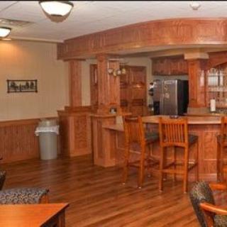 A cozy kitchen interior featuring wooden counters and bar stools.
