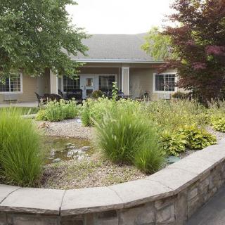 A beautifully landscaped garden in front of a house.