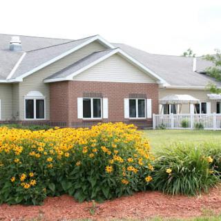 A suburban house with well-maintained landscaping and vibrant flower beds.