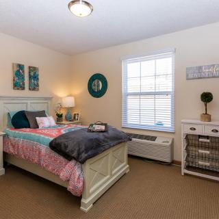 A cozy bedroom with soft lighting and tasteful decor.