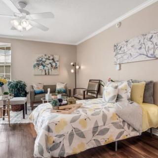A cozy and well-decorated bedroom featuring a comfortable bed, stylish artwork, and elegant decor.