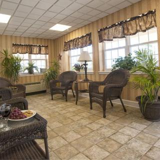 A cozy waiting area with wicker chairs and abundant natural light.