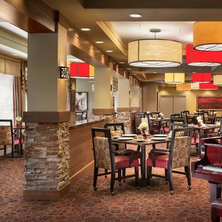 A modern restaurant interior with arranged tables and stylish lighting.