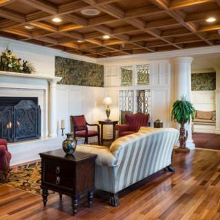 Elegant living room with a fireplace and wooden flooring.